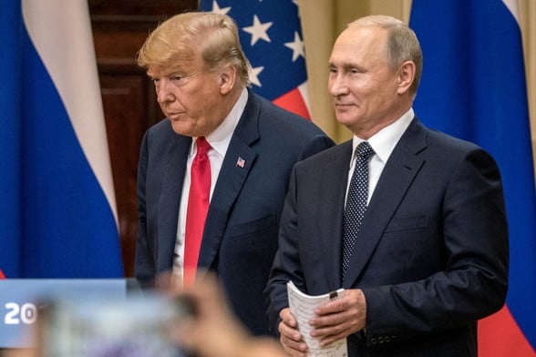 Trump, looking even more dull and out of it than usual, standing next to pleased-looking Putin in Helsinki in 2018.