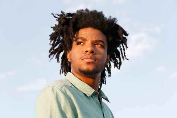Portrait of a young African American man with large dreads (Credit: Mireya Acierto/Getty Images)