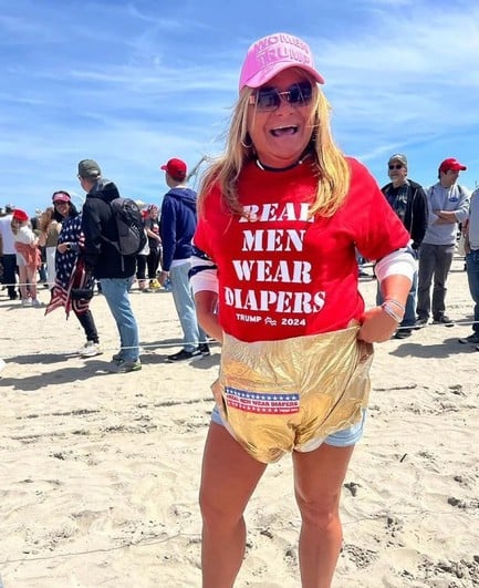 A woman wearing a real men wear diapers shirt and a gold diaper 