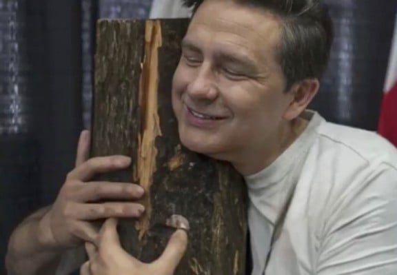Pierre Poilievre hugging wood.  